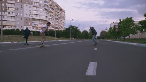 group of young people skateboarding on the road in the early morning, cinematic shot, slow motion