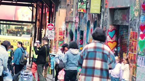 people observing graffiti in melbourne's hosier lane