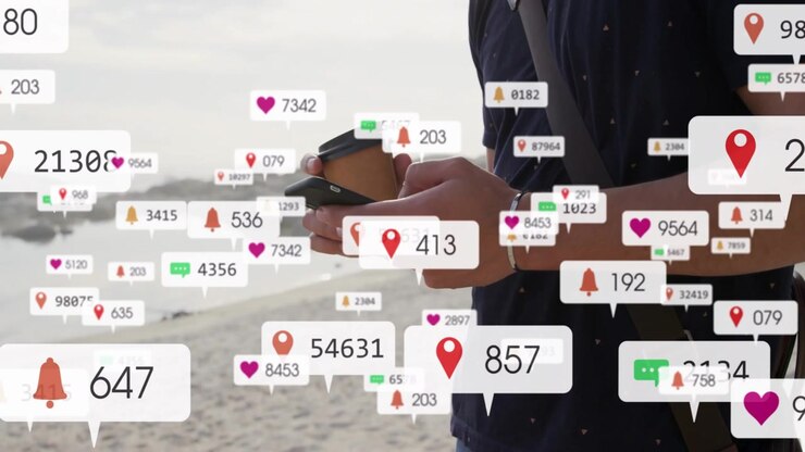 Mand står på strand med kop, tjekker opdateringer, mens sociale ikoner vises, fylder rammen og dækker hænderne.