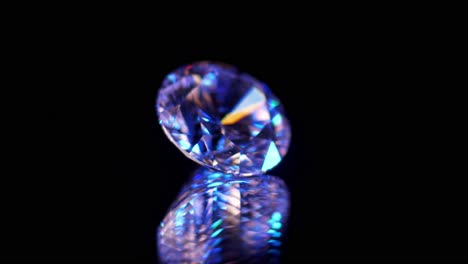 macro shot of high quality diamond isolated on black relfecting surface, illuminated by purple and blue light