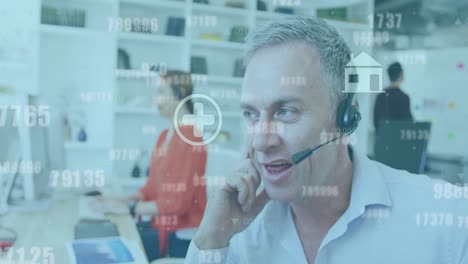 animation of data processing and icons over caucasian business people using phone headsets in office