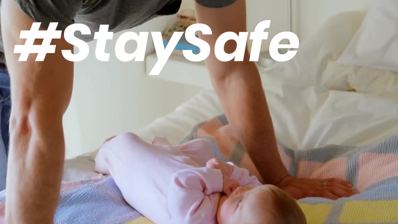 Animation of stay safe text over father and child at home