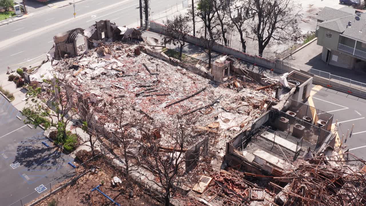 Close-up aerial shot flying over the Altadena Community Church and Meher Montessori School that were burned by the Eaton Fire in Altadena, California. 4K