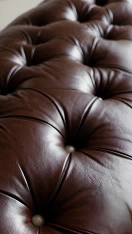 close-up of brown tufted leather upholstery