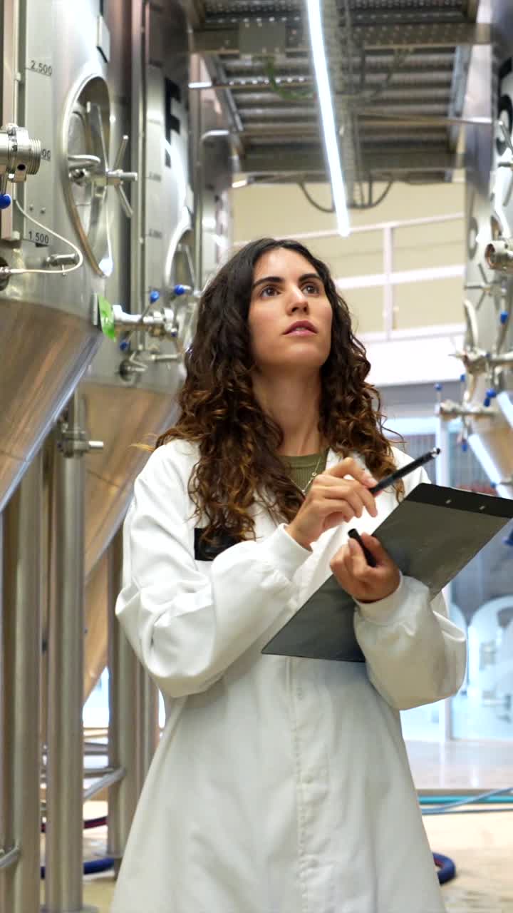 Scientist Inspecting Brewery Tanks