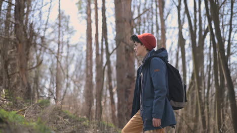 a young woman with short hair takes a walk in the woods