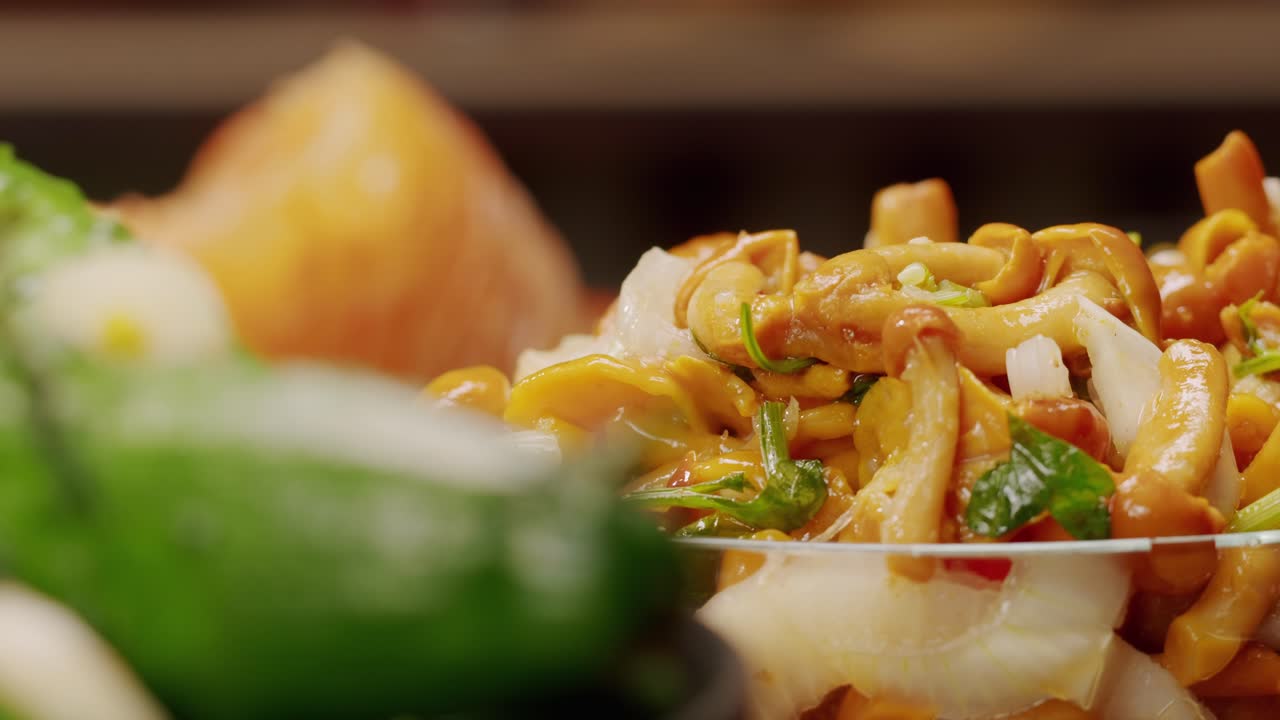 Close-up of fermented yellow honeydew mushrooms with onion in plate. Preservation of vegetables in glass jars. Fermentation preserved mushroom with spices.