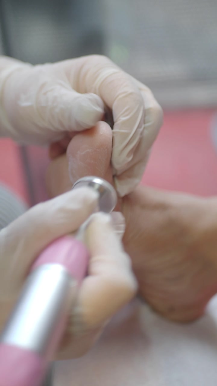 Close-up of a Pedicurist Using an Electric File on a Client's Toes