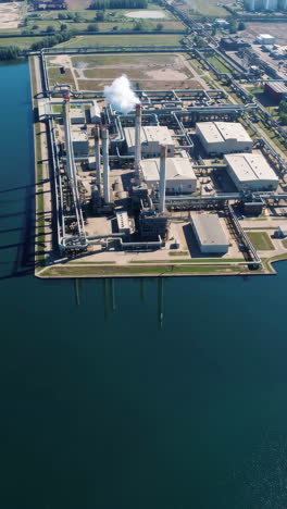 aerial view of industrial complex by water
