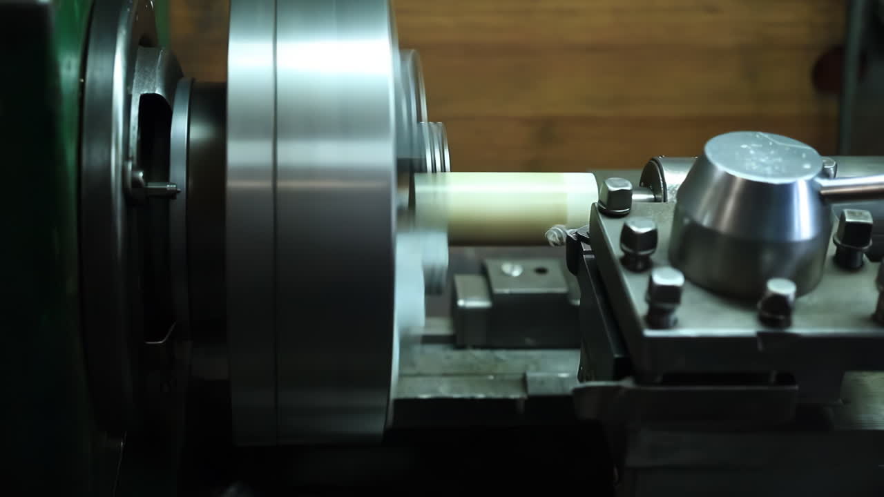 Lathe technician engineer worker service Skilled machinist working intently on a large industry in metal factory workshop with Large Machines