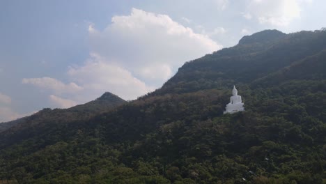 luang por khao, wat theppitak punnaram, descending aerial 4k footage of the famous giant white buddha on a mountain side in pak chong, nakhon ratchasima in thailand