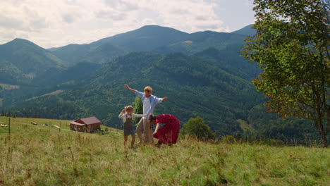 rodzina bawi się na green hill. ludzie biegają z wyciągniętymi rękami.