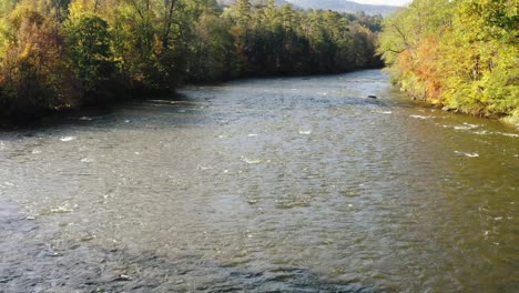 aerial close up view of housatonic river passing by the scenic hilly landscape of litchfield county, connecticut,united states on a sunny morning