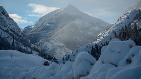 time lapse, idyllic mountain winter landscape, snow capped hills and valley on sunny morning