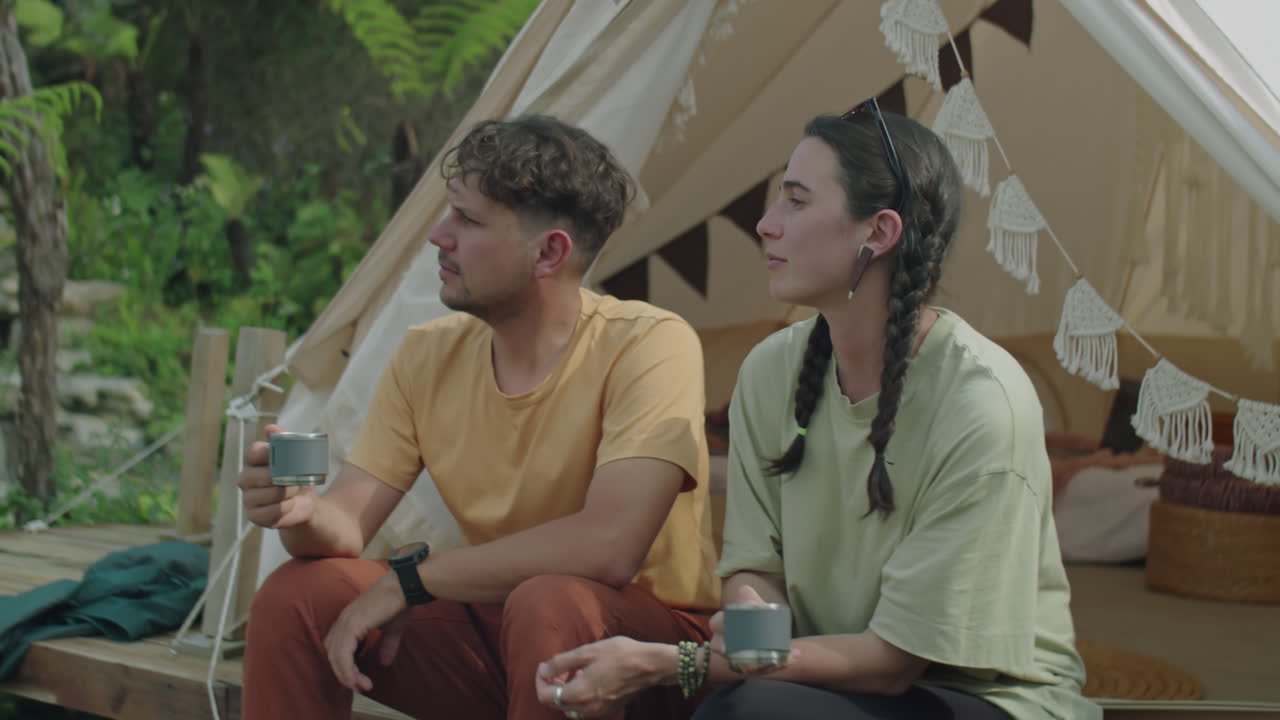 Young Couple Drinking Tea and Talking at Glamping in Nature