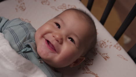 Cute-baby-laughing-and-smiling-in-crib