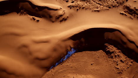 bird’s-eye drone shot capturing the diverse shapes and colors of southern utah’s pink sand dunes.