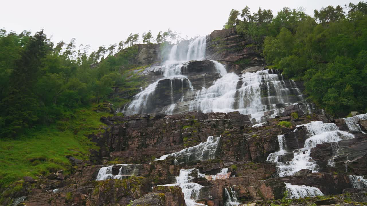 Waterfall in Norway. Scenic Tvindefossen cascade in Scandinavia. Landscape river nature. Natural phenomenon.