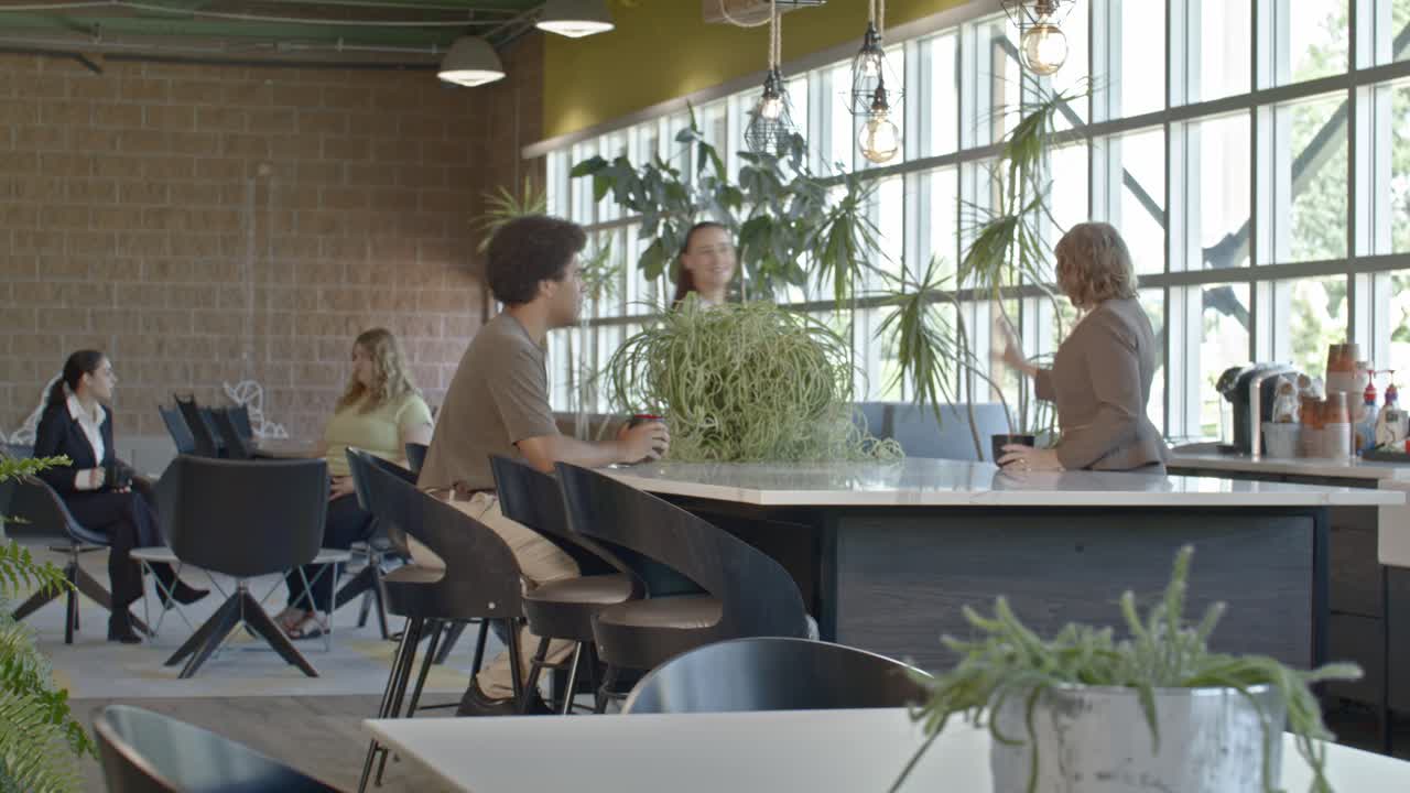 Office setting side shot with one senior citizen woman and four younger workers with video dolly shot