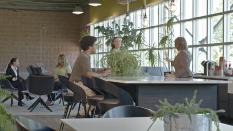 office setting side shot with one senior citizen woman and four younger workers with video dolly shot