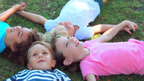 Children-lying-on-grass-and-smiling