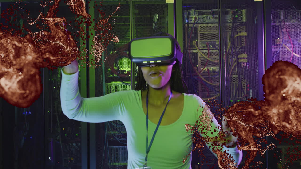 In server room, person wearing VR headset interacting with animation particles
