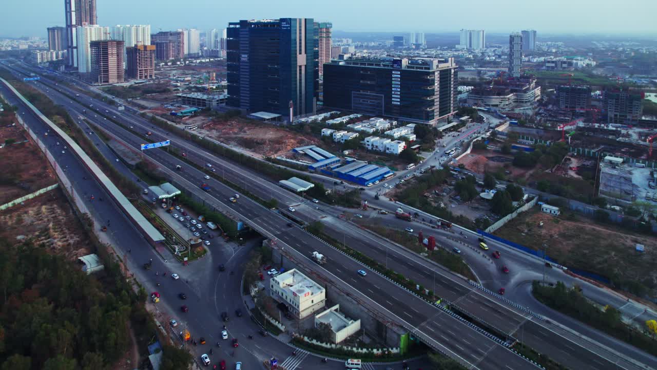 Hyderabad Outer ring road with financial district circle and glass facade building at ORR Exit 1, nanakramguda, financial district, hyderabad, telangana, india. day time, push in, drone shot, 4k.