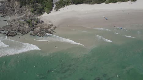 Surfers-At-The-Scenic-Clarkes-Beach-In-New-South-Wales,-Australia---drone-shot