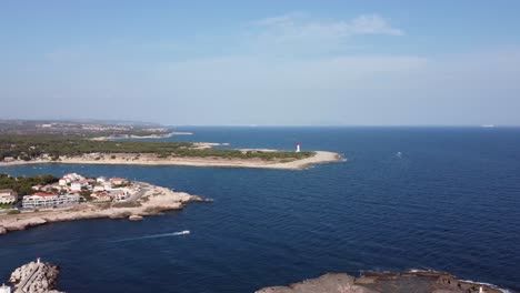 slow cinematic 4k drone clip over a beach towards a lighthouse by plage du verdon and bay of marseille in background in france