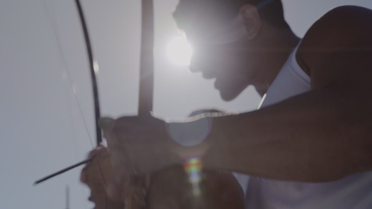 People playing the berimbau, a traditional Brazilian instrument, outdoors