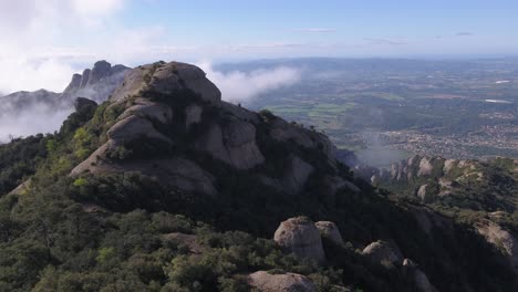 aerial forward over montserrat massif and valley in background, catalonia