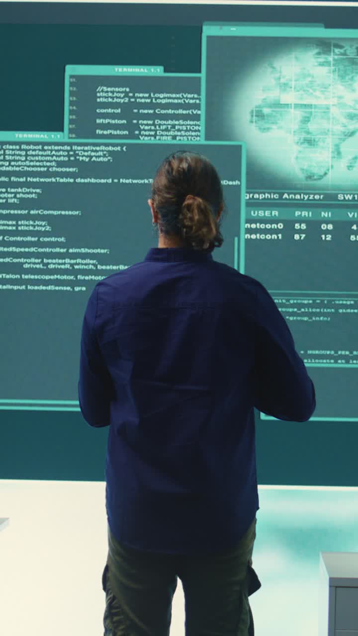 Man Analyzing Code and Data on Large Digital Screen