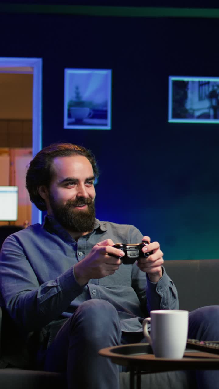 Vertical video Happy gamer at home gaming and enjoying leisure time