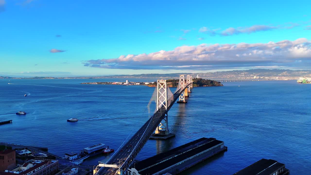 Drone captures cars traveling westbound toward San Francisco on the San Francisco–Oakland Bay Bridge, with the San Francisco Bay and Yerba Buena Island visible in the background