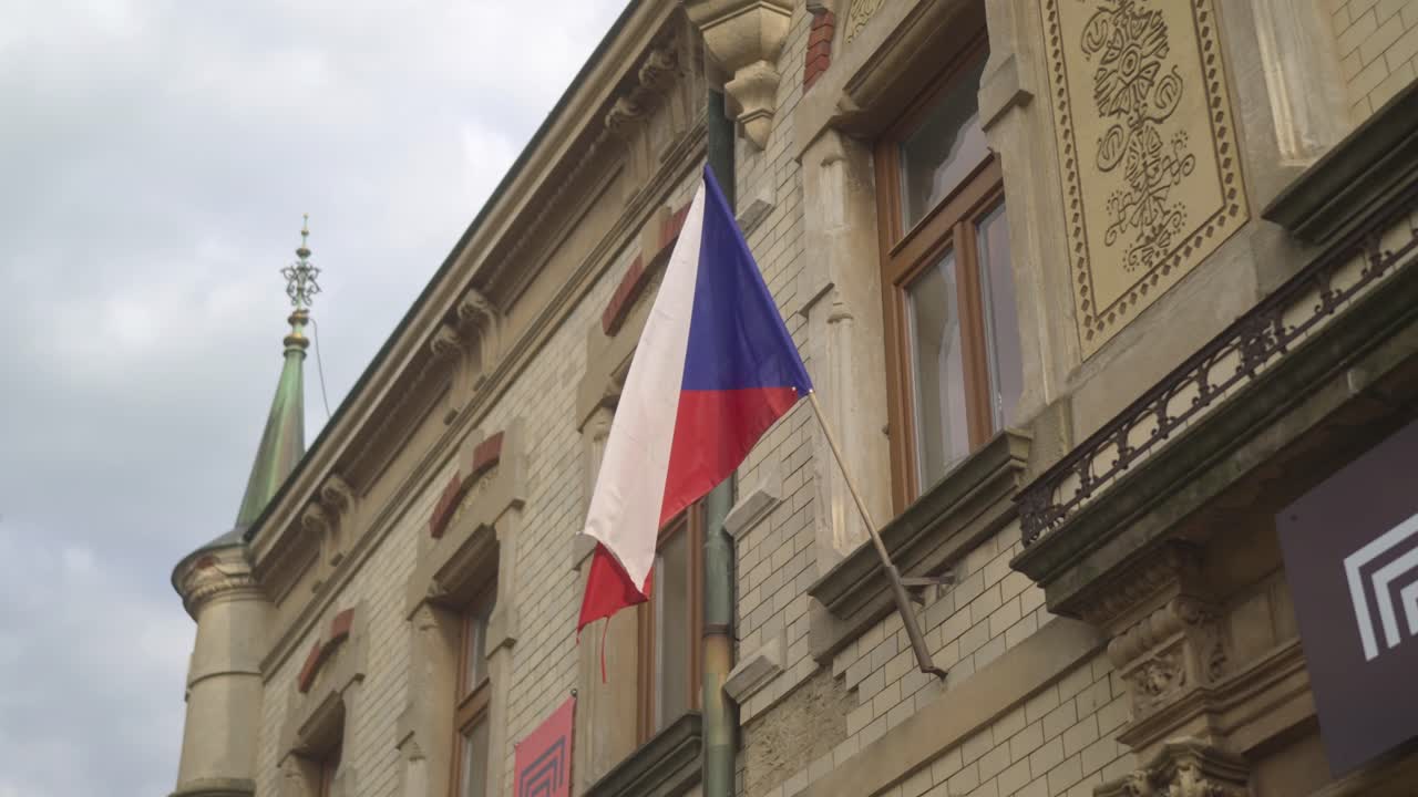 Czech flag on a pennant flutters in the wind on a historic building. The national symbol of the Czechs