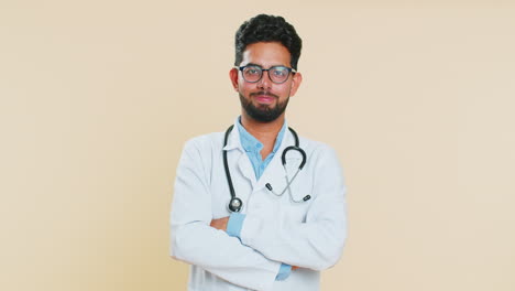 happy indian doctor man removing, taking off medical protective mask, ending of flu pandemic