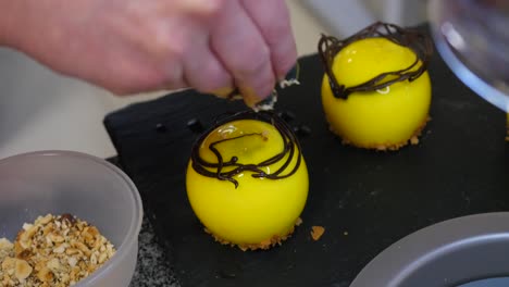 chef preparing decorative yellow dessert bites