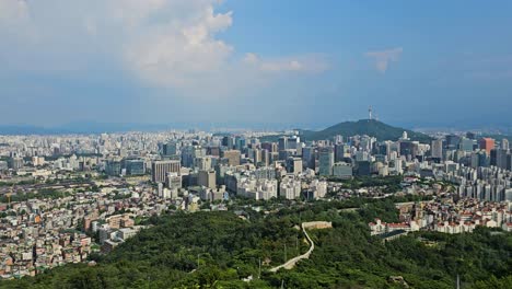 scenic timelapse establishing overview of seoul south korea skyline from bugaksan mountain, showcasing namsan tower and seoul city wall.