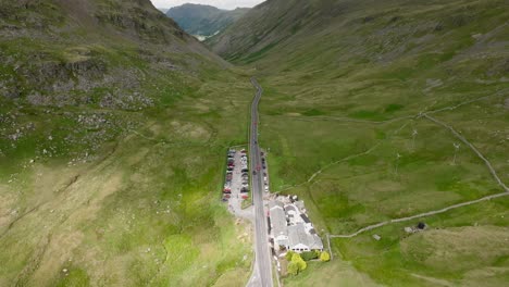 kirkstone pass valley summit with reveal of the kirkstone pass inn. moving cloud shadows on landscape. summer. lake district, cumbria, uk