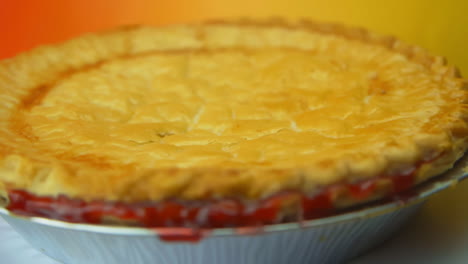 [cámara utilizada: canon c300] un pastel de cerezas giratorio, con corteza dorada y glaseado de cerezas que sale por los lados