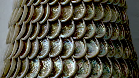 push-in slider shot toward south african abalone shells glued together in a pattern to make a tower