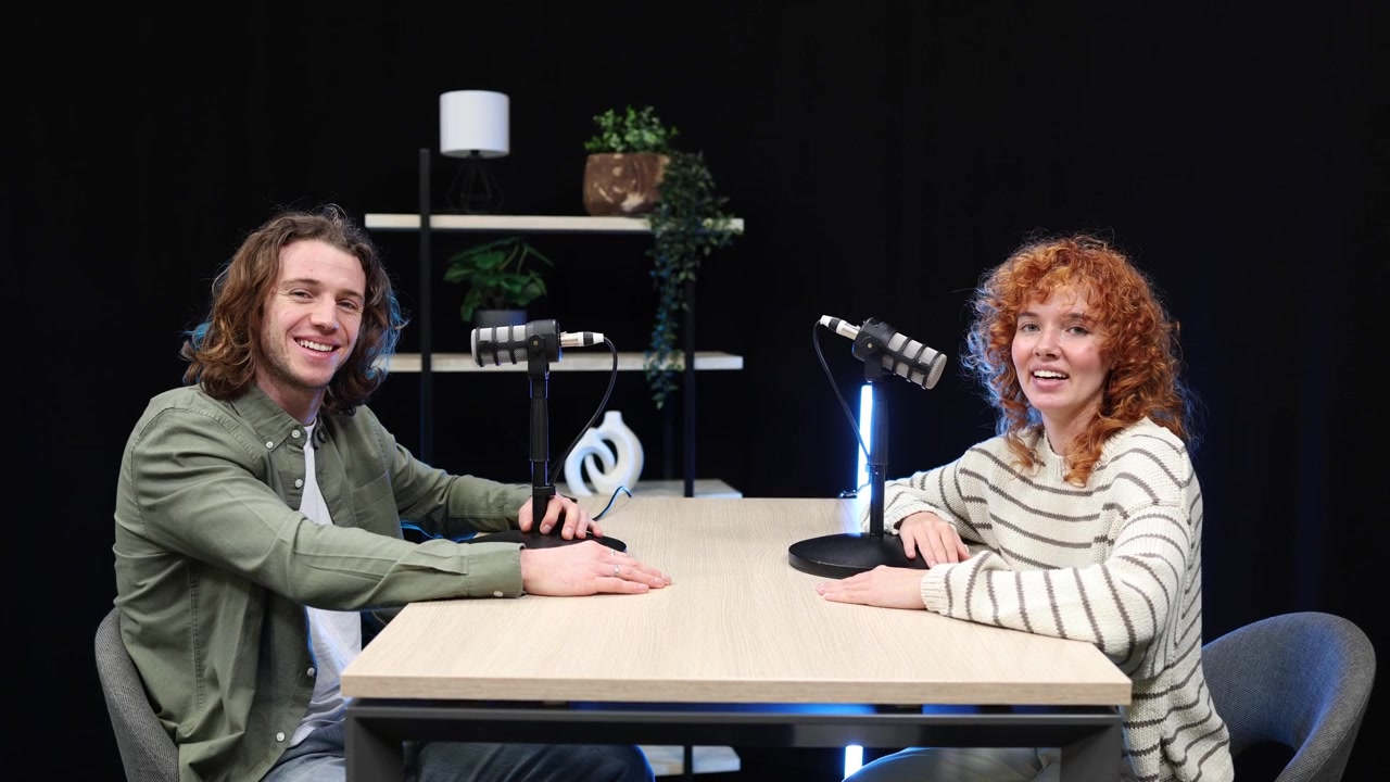 Young Man and Woman Hosting a Podcast in a Studio