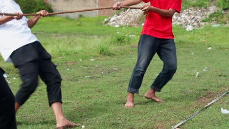young indonesian men celebrating independence day with variety of traditional games and activities