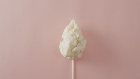 Video-of-marshmallow-on-stick-lying-on-pink-surface