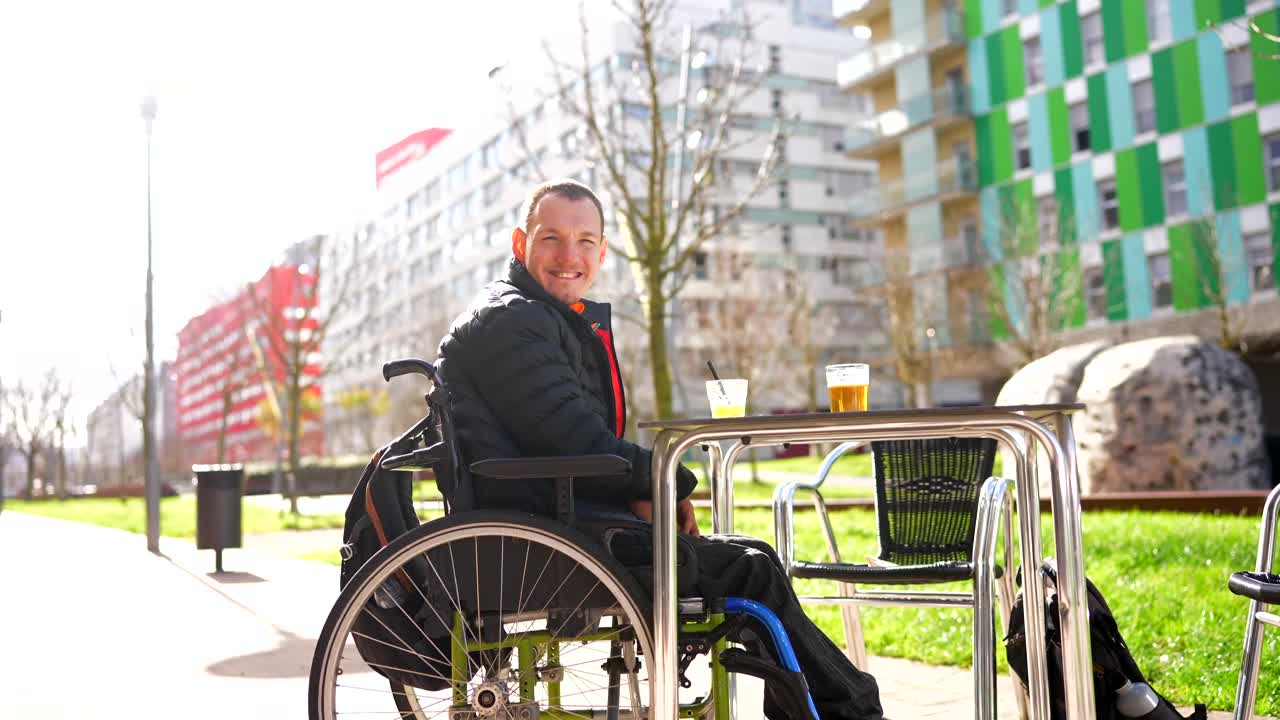 Man in Wheelchair Enjoying Drinks Outdoors