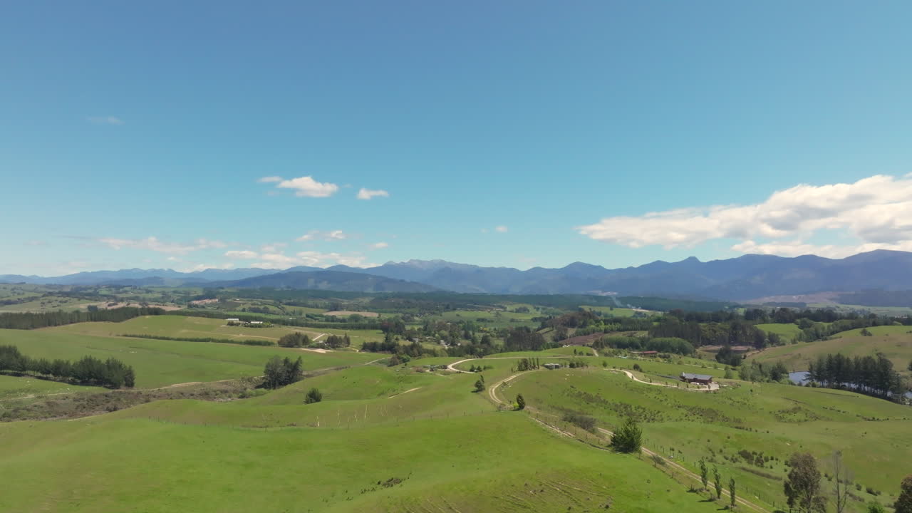Aerial drone shot of the rolling green fields in the Tasman district of New Zealand