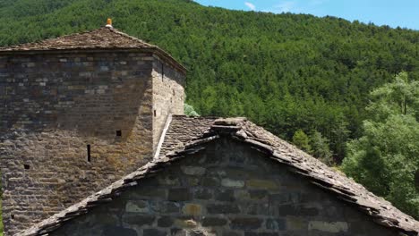 aerial view above a mountain church in a valley