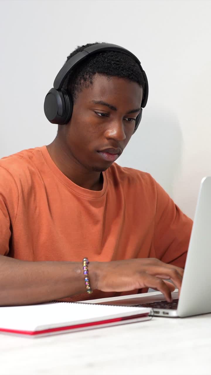 Man studying with laptop and headphones