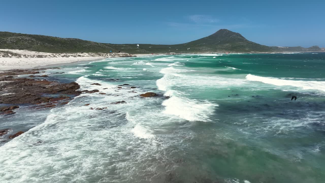 Aerial view of skilled tourists and locals kite surfing at Platboom near Cape Town