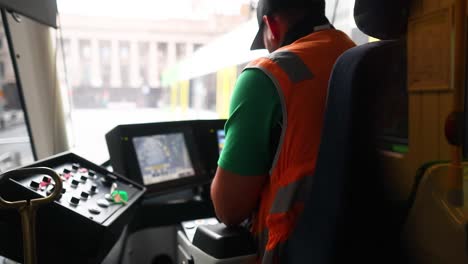 tram driver focused on controls in melbourne